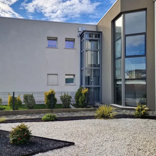 Haus, weiß gestrichen, mit Mangusta Homelift an der Au0enseite